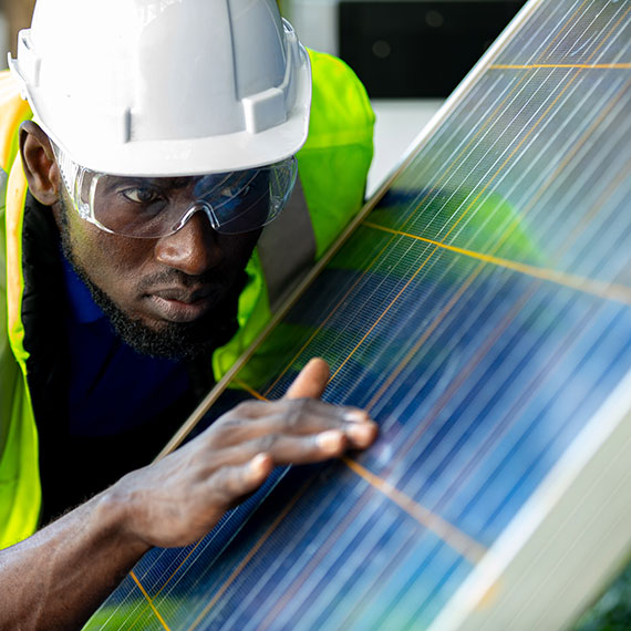 Man inspecting a solar panel.